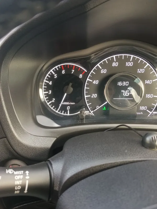 Приборная панель Note E12 на стоянке, тахометр около тысячи оборотов, под спидометром горит зеленый значок холодного двигателя